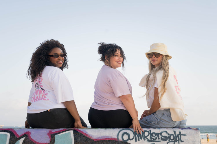Three Fmme Strng community members wearing lavender and cream apparel