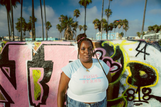 Woman wearing the FSA Est. 2025 Vintage Varsity Tee at Venice Beach